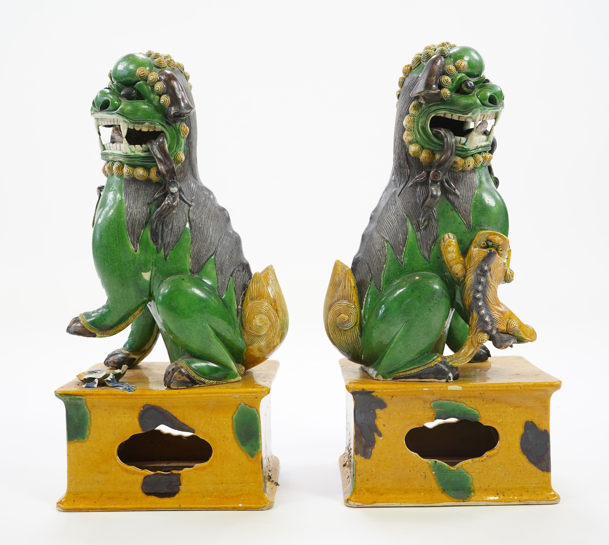 A pair of large Chinese sancai-glazed biscuit figures of Buddhist temple lions, 19th century